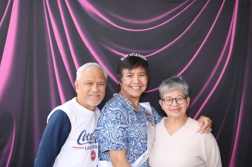 Guests celebrating a 60th birthday at the photo booth