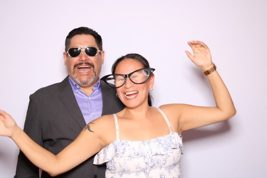 Guests laughing with oversized photo booth props