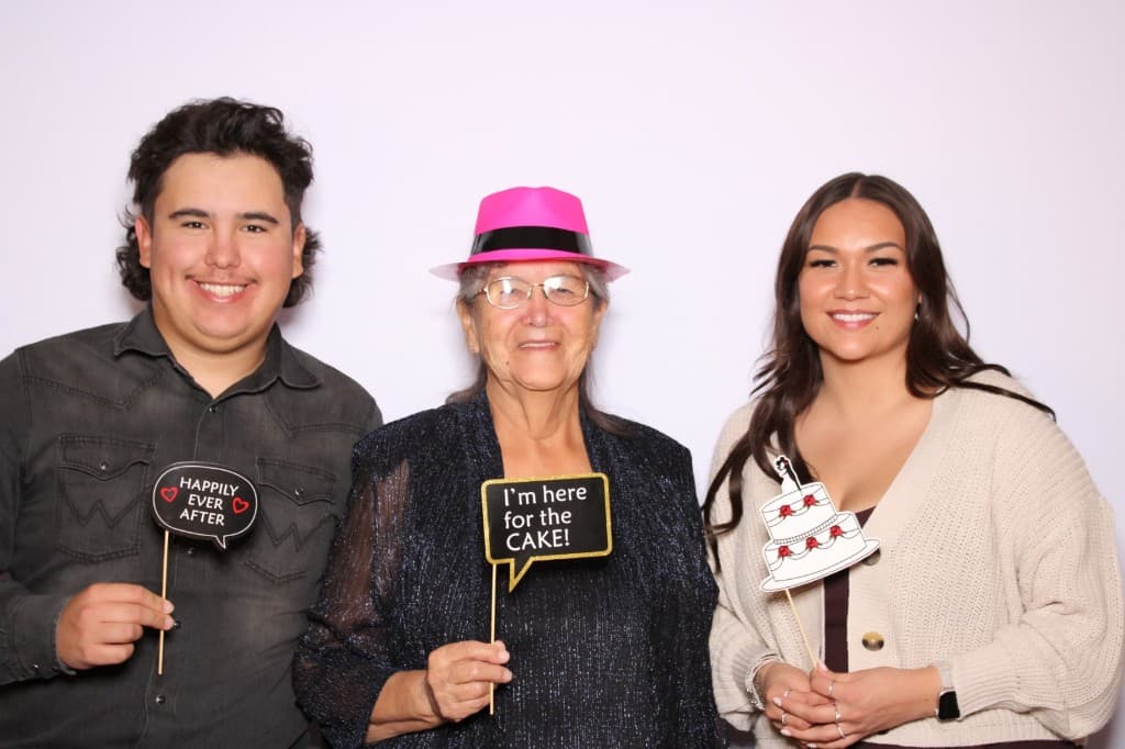 Multi-generational wedding guests with booth props